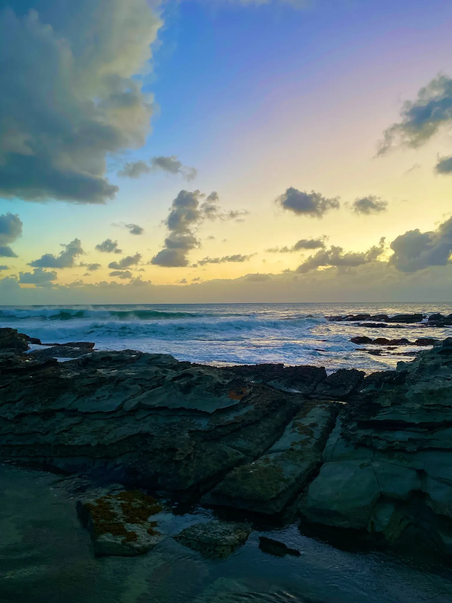 Dark coastal rocks at dawn