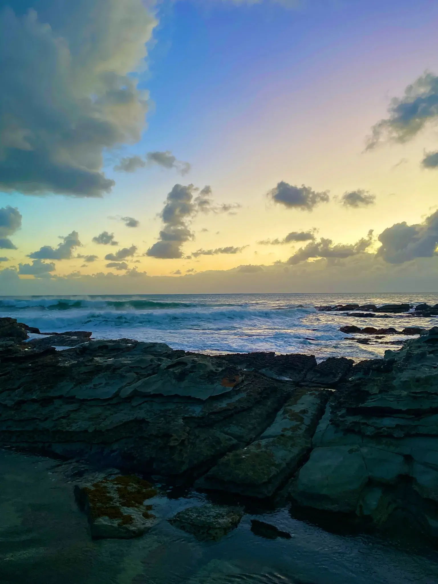 Dark coastal rocks at dawn